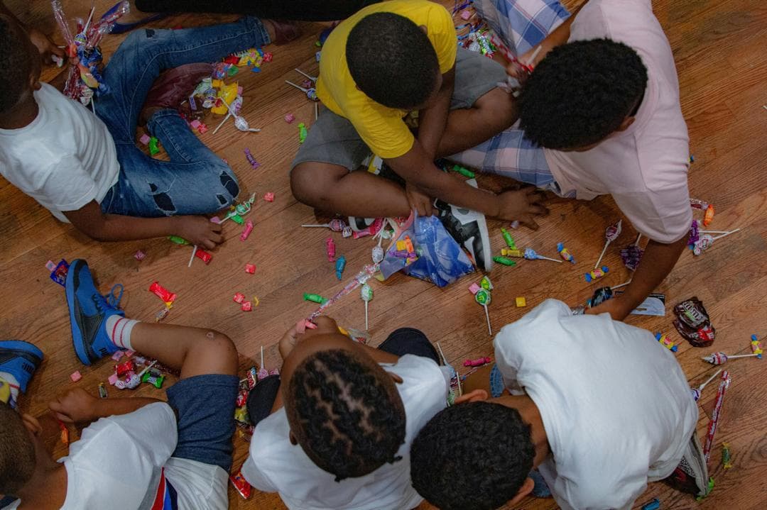 Teacher helping children with writing in a classroom session